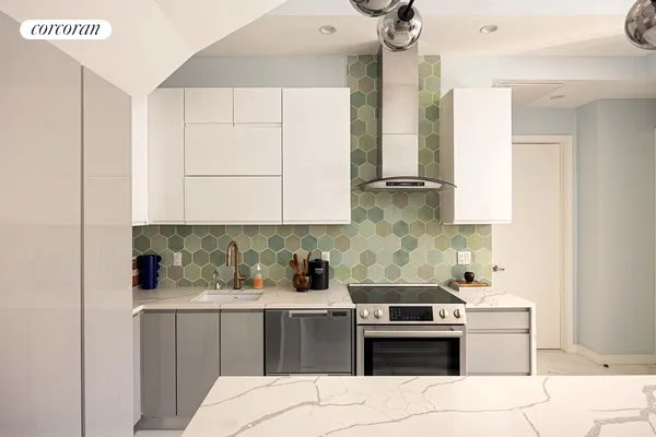 a kitchen with a stove oven and sink