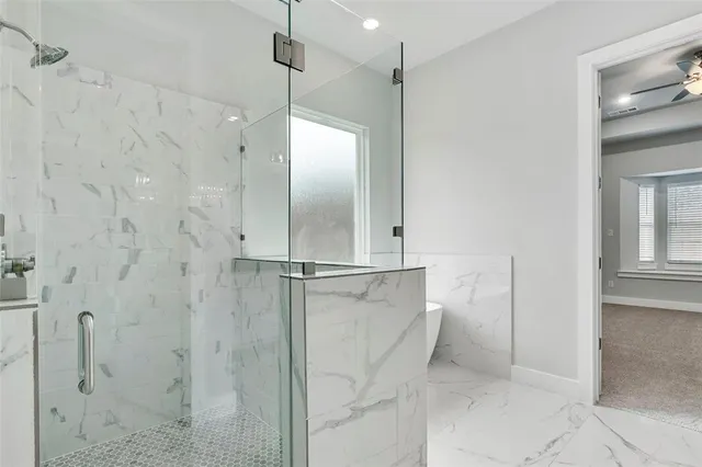 a bathroom with a shower and a glass door