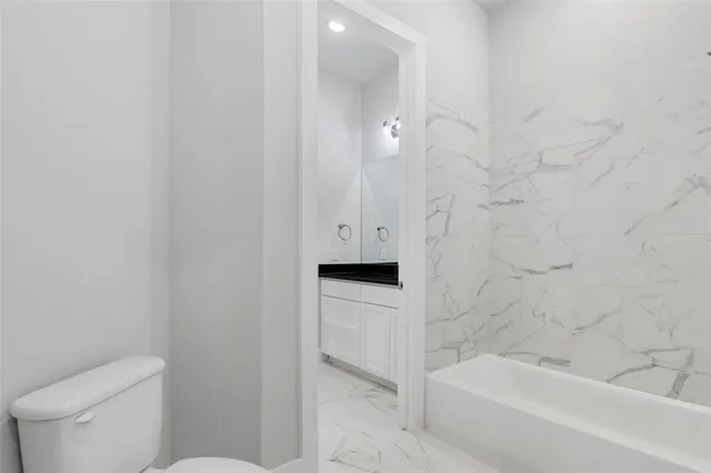 a bathroom with a bathtub toilet and sink