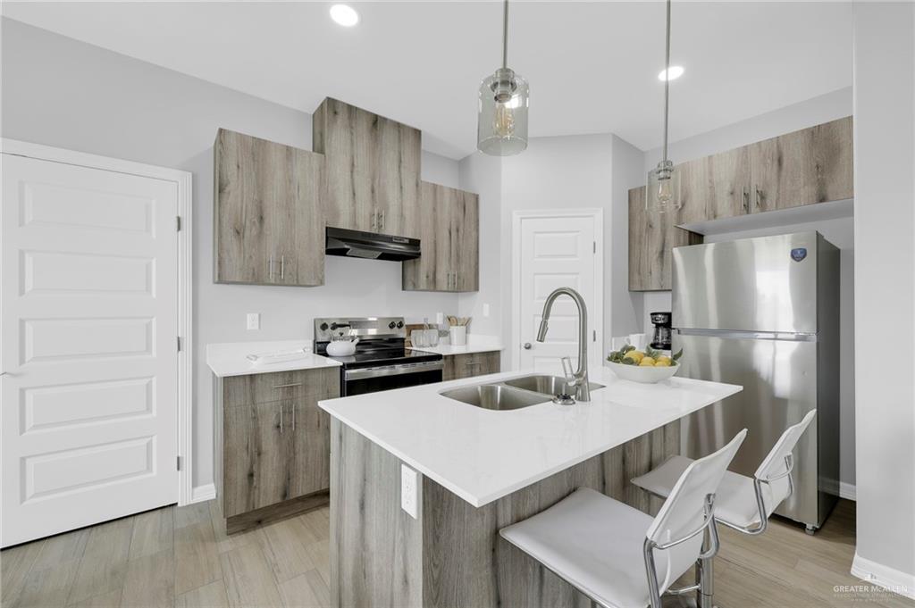 600 Bridget Street Weslaco, TX 78596 - Photo 5 of 23 a kitchen with stainless steel appliances a stove a sink a refrigerator and cabinets