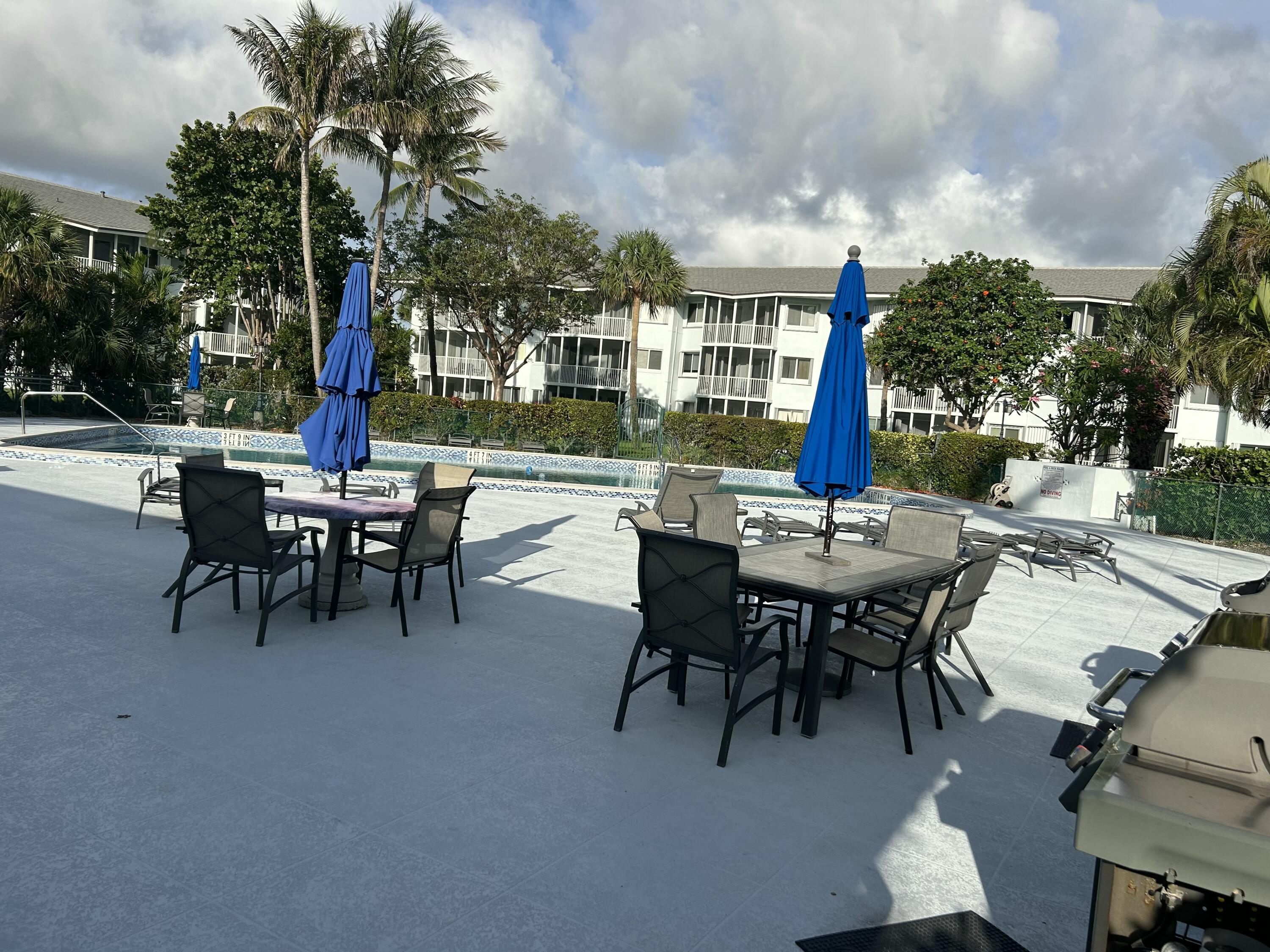 2760 Banyan Road, Unit 25A Boca Raton, FL 33432 - Photo 11 of 12 a view of a patio with a table and chairs