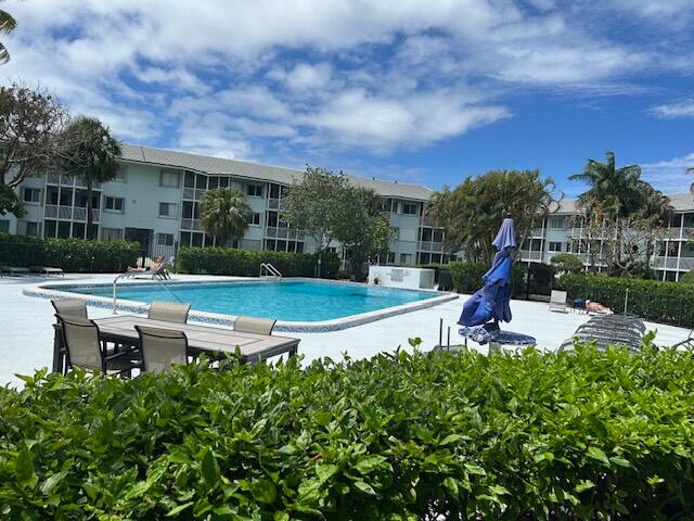 2760 Banyan Road, Unit 25A Boca Raton, FL 33432 - Photo 12 of 12 a view of a swimming pool and lounge chairs