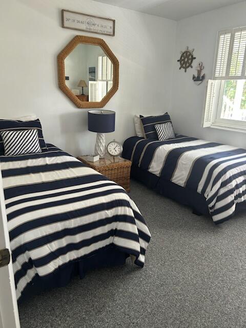 2760 Banyan Road, Unit 25A Boca Raton, FL 33432 - Photo 2 of 12 a bedroom with a bed and a mirror