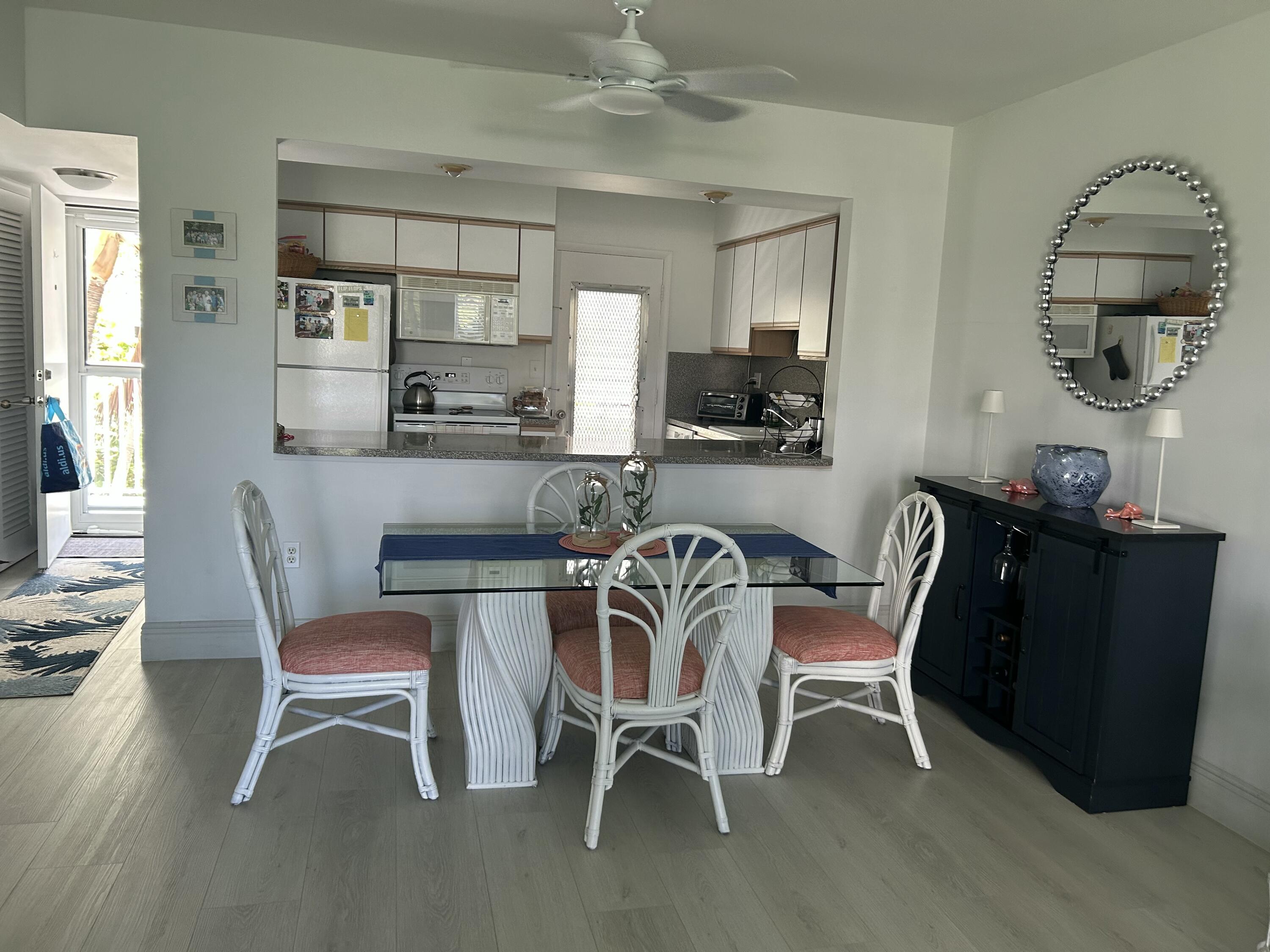 2760 Banyan Road, Unit 25A Boca Raton, FL 33432 - Photo 5 of 12 a dining room with furniture and window
