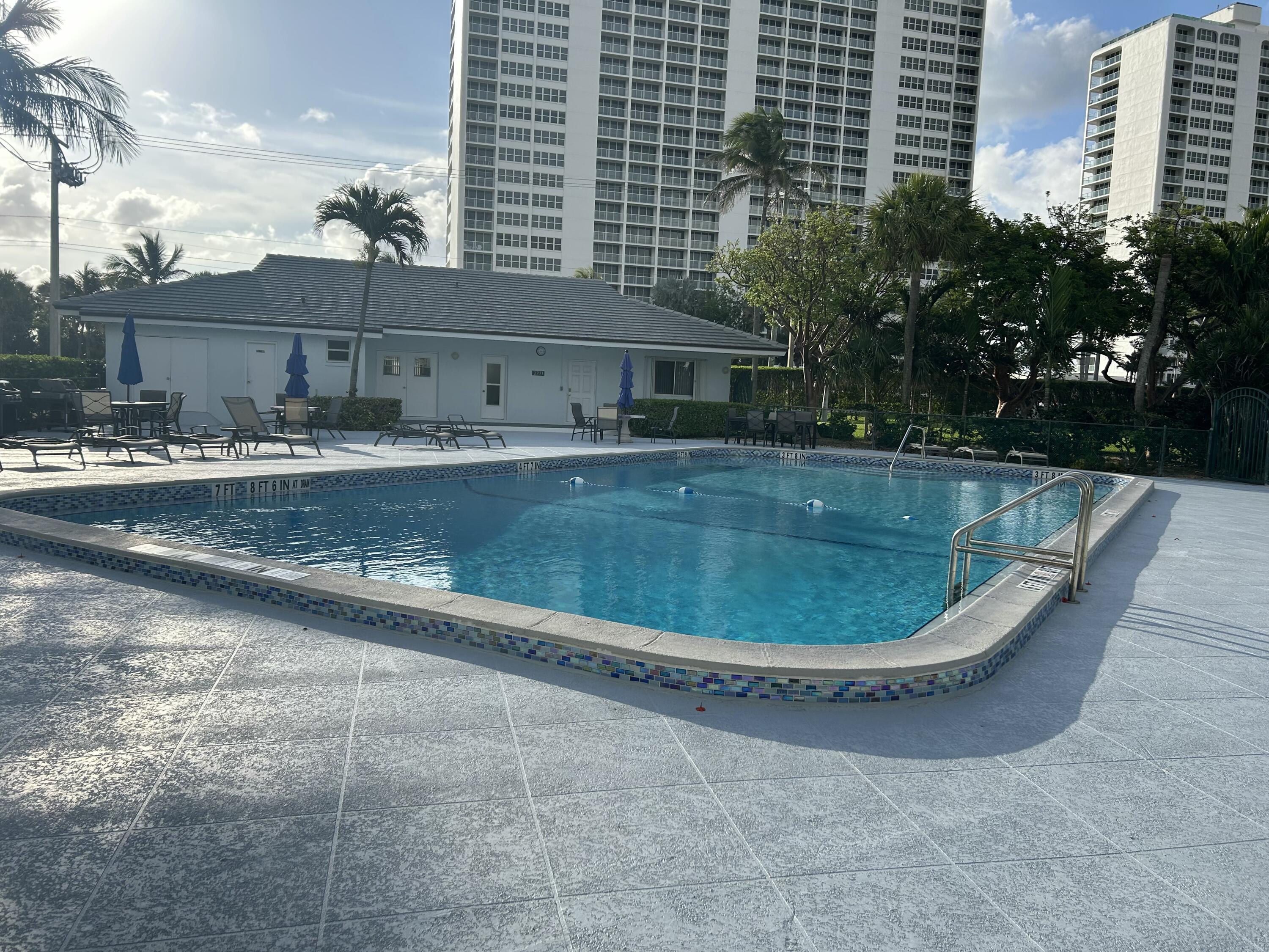 2760 Banyan Road, Unit 25A Boca Raton, FL 33432 - Photo 10 of 12 a view of a swimming pool with a yard
