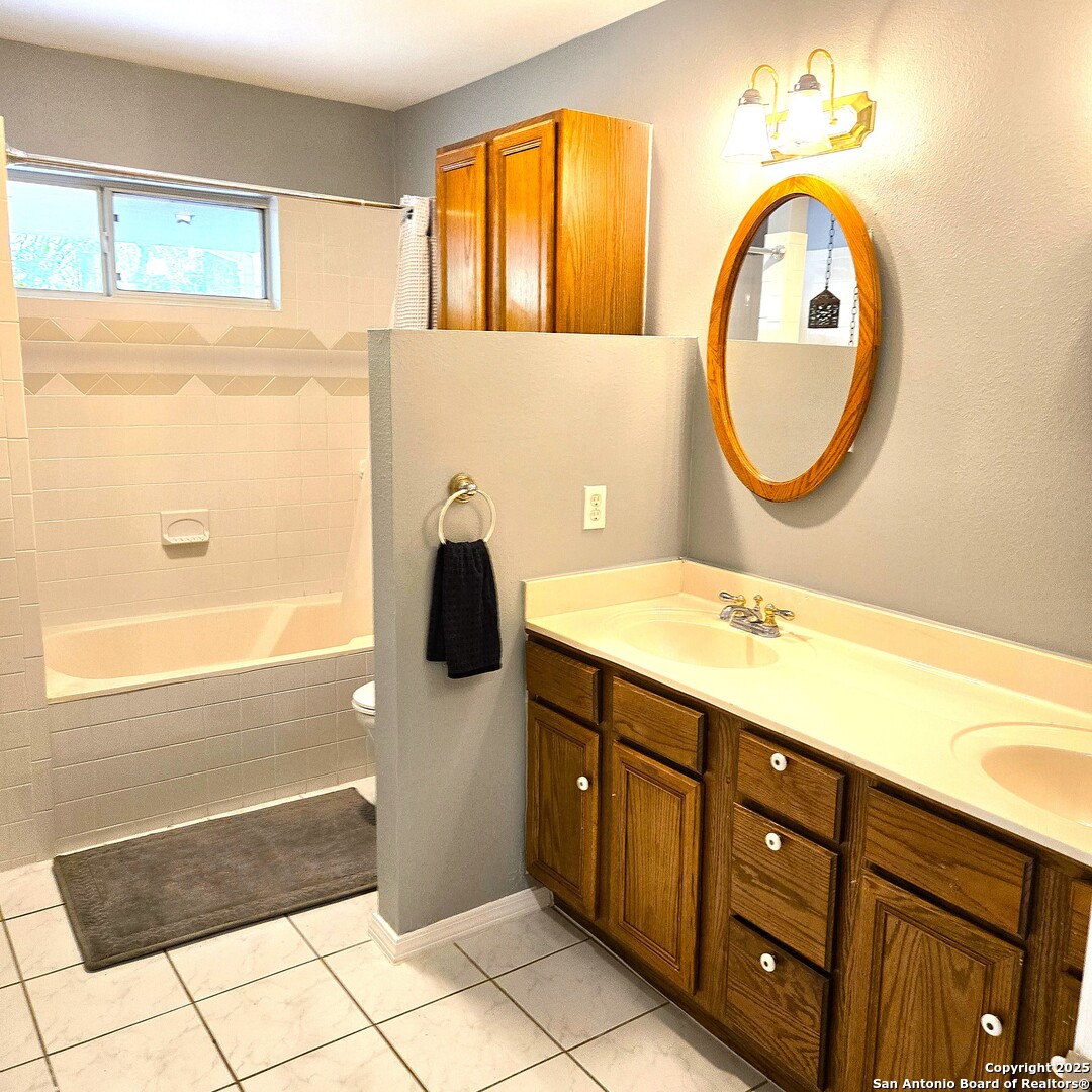 23007 South Breeze Street San Antonio, TX 78258 - Photo 16 of 27 a bathroom with a sink and a mirror