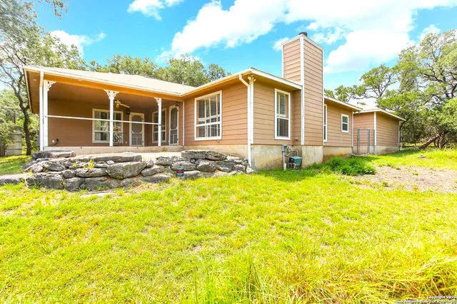 a front view of house with yard outdoor seating and barbeque oven