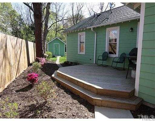 103 Georgetown Road Raleigh, NC 27608 - Photo 11 of 12 Spacious deck is of the kitchen. Wired storage building in the back is detached. Exterior Back