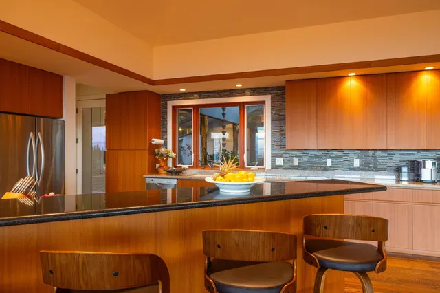 a view of a dining room and livingroom with furniture wooden floor a chandelier