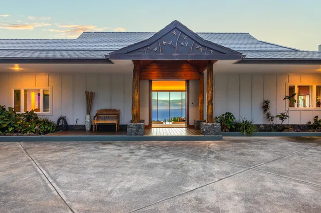 a view of roof deck with couches and potted plants