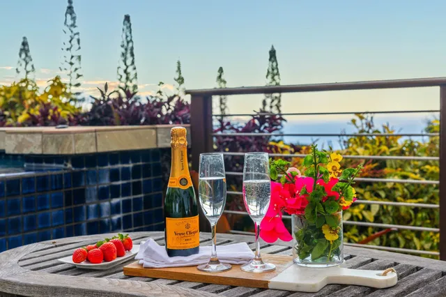 a view of a balcony with table and chairs and wooden floor
