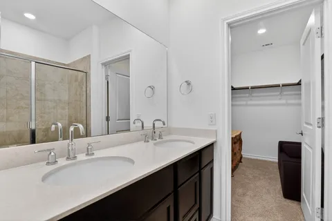 a bathroom with 2 sink and a mirror