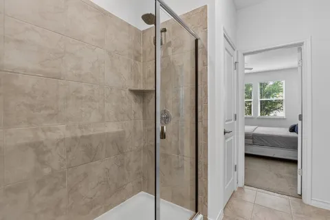 a bathroom that has a glass shower door
