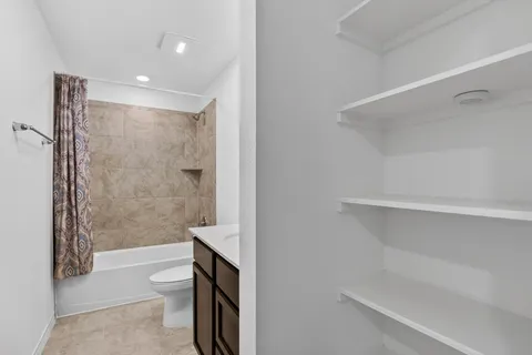 a bathroom with a shower a toilet and sink