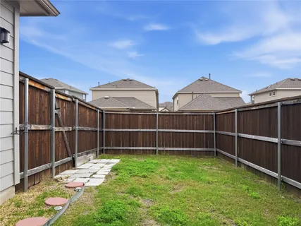 a view of a garden with a wooden fence
