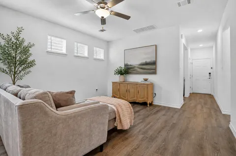 a bedroom with bed and wooden floor