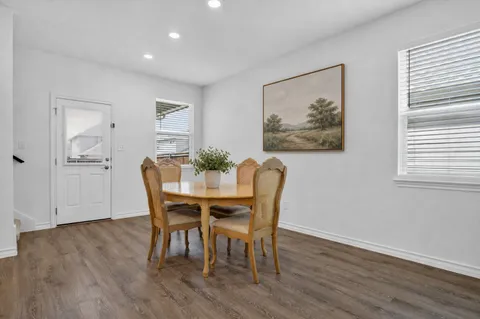 a view of a dining room with furniture and wooden floor