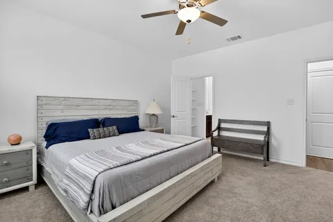 a bedroom with a bed and a chandelier