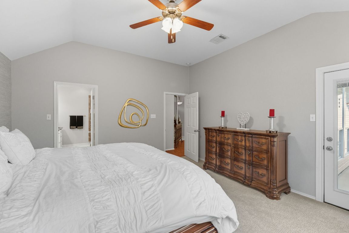 15202 Sun-Bird Lane Austin, TX 78734 - Photo 16 of 28 a bedroom with a bed and a chandelier