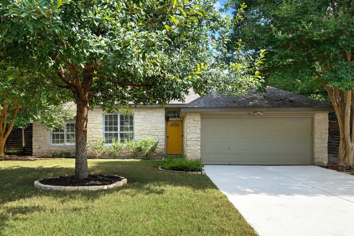 15202 Sun-Bird Lane Austin, TX 78734 - Photo 27 of 28 a front view of a house with a yard and garage