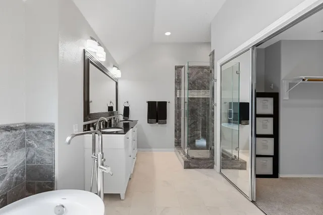 a bathroom with a toilet a sink and shower