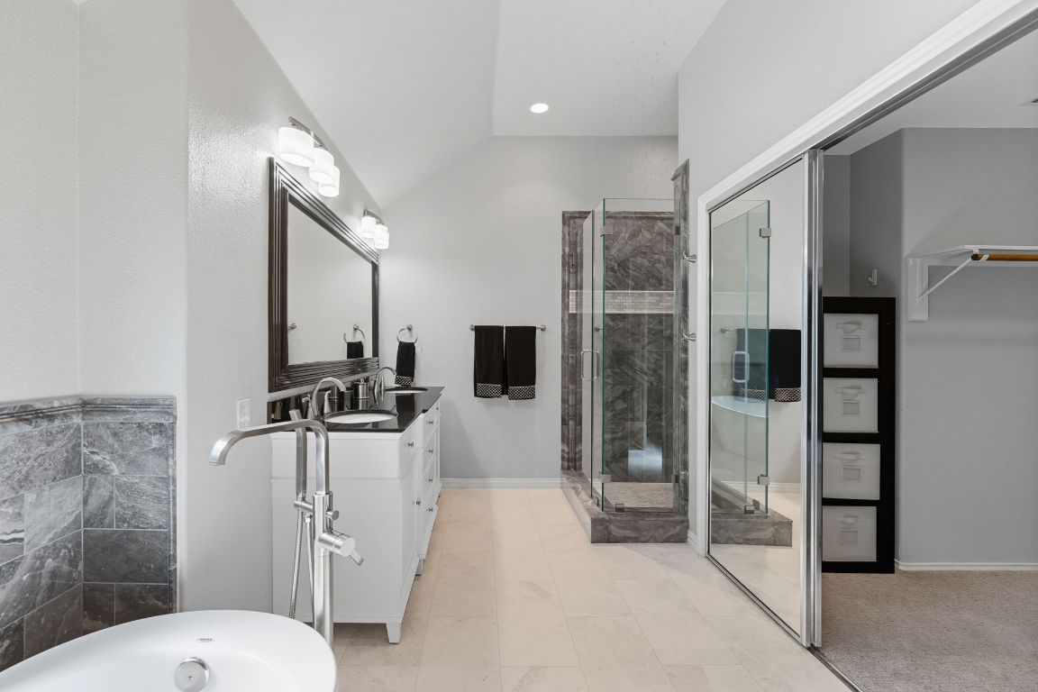 15202 Sun-Bird Lane Austin, TX 78734 - Photo 4 of 28 a bathroom with a toilet a sink and shower