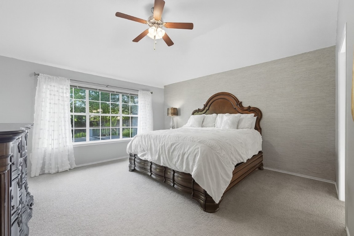 15202 Sun-Bird Lane Austin, TX 78734 - Photo 5 of 28 a spacious bedroom with a bed and a large window
