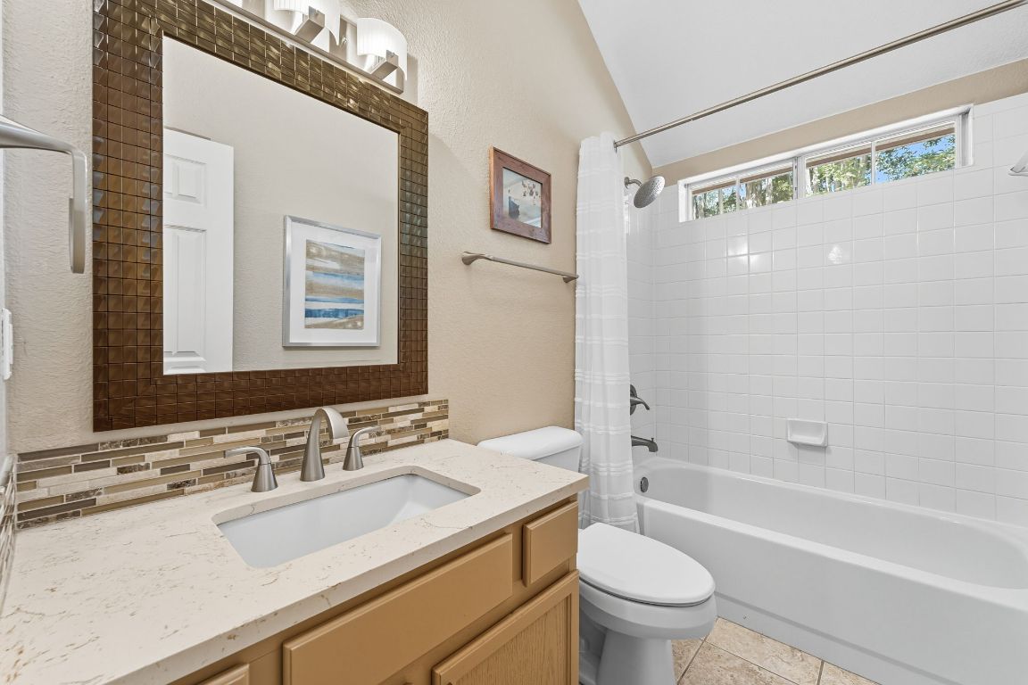 15202 Sun-Bird Lane Austin, TX 78734 - Photo 9 of 28 a bathroom with a granite countertop sink toilet and shower