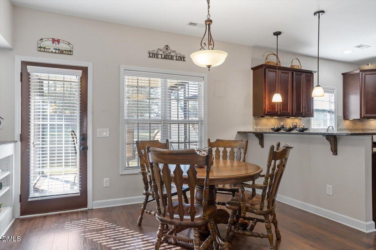 109 North Sunset Ridge Drive Willow Spring, NC 27592 - Photo 11 of 54 a view of a dining room with furniture window and wooden floor