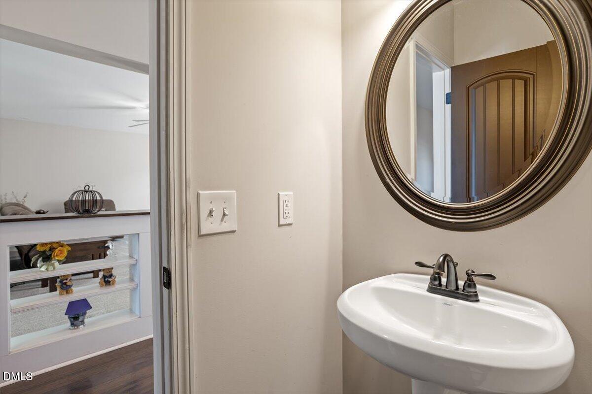 109 North Sunset Ridge Drive Willow Spring, NC 27592 - Photo 17 of 54 a bathroom with a sink and a mirror