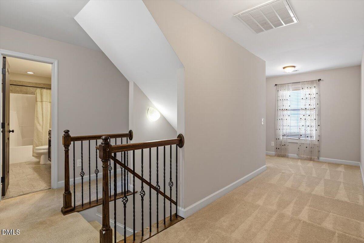 109 North Sunset Ridge Drive Willow Spring, NC 27592 - Photo 18 of 54 a view of a hallway with windows and stairs