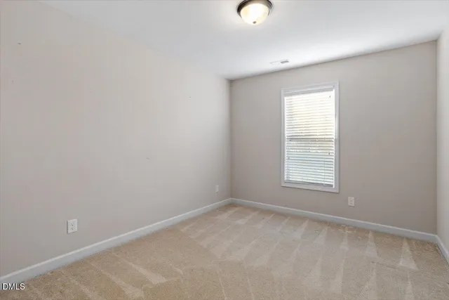 a bathroom with double vanity sink a toilet and a mirror