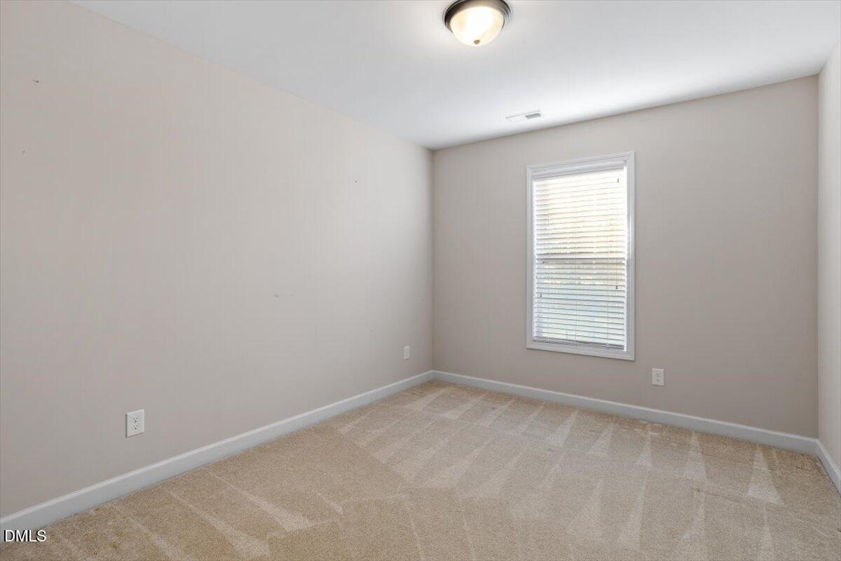 109 North Sunset Ridge Drive Willow Spring, NC 27592 - Photo 29 of 54 an empty room with a window