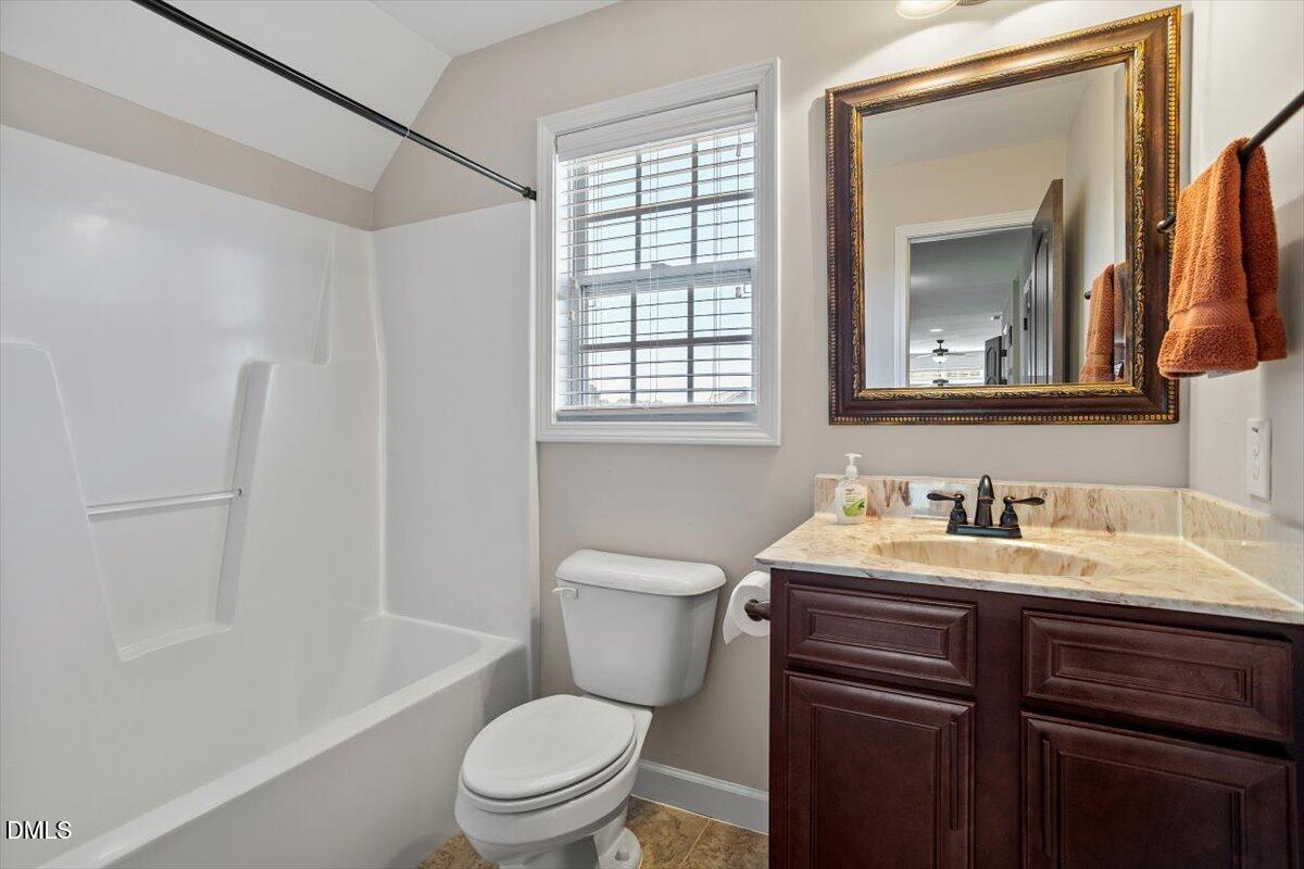 109 North Sunset Ridge Drive Willow Spring, NC 27592 - Photo 35 of 54 a bathroom with a toilet a sink a tub and a mirror