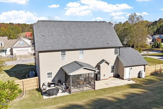 a view of a house with backyard and sitting area