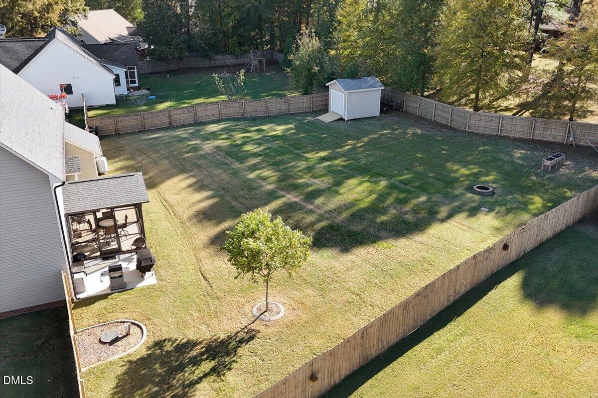 109 North Sunset Ridge Drive Willow Spring, NC 27592 - Photo 42 of 54 a view of a swimming pool with a yard and potted plants