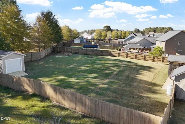 a aerial view of a house with a yard and sitting area