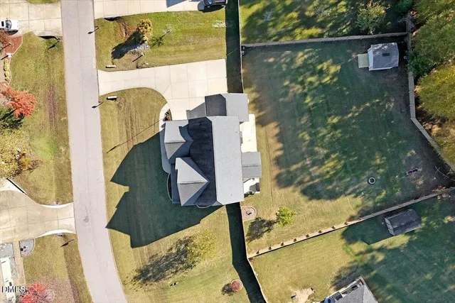 an aerial view of a houses with a lake