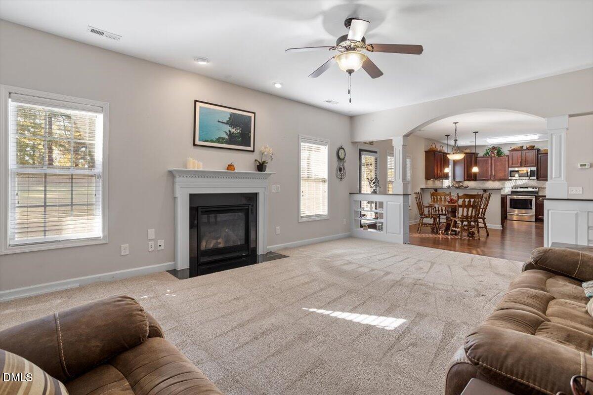 109 North Sunset Ridge Drive Willow Spring, NC 27592 - Photo 7 of 54 a living room with furniture a fireplace and a window