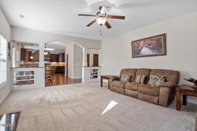 a living room with furniture and kitchen view