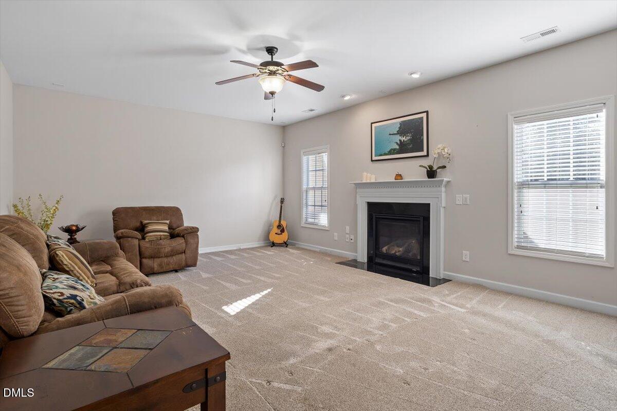 109 North Sunset Ridge Drive Willow Spring, NC 27592 - Photo 10 of 54 a living room with furniture a fireplace and a flat screen tv
