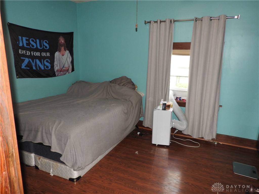 2105 East Loy Road Piqua, OH 45356 - Photo 17 of 26 This cozy bedroom features durable hardwood flooring and natural light.