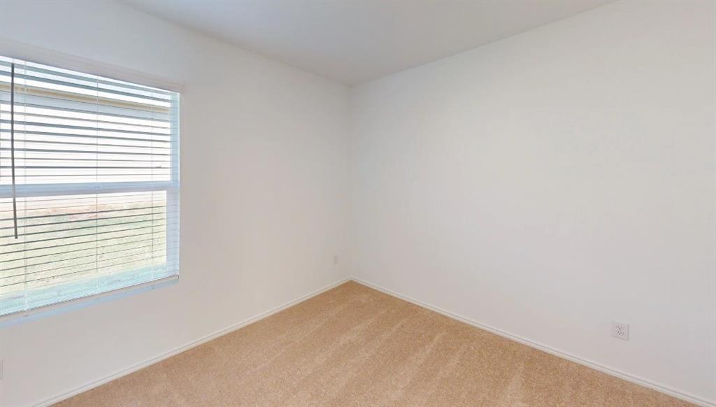 9757 Platteview Road Fort Worth, TX 76179 - Photo 8 of 19 Room featuring light-toned carpeting, neutral wall finishes, and a window with horizontal blinds