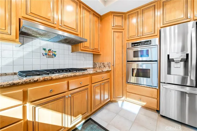a kitchen with a refrigerator and cabinets