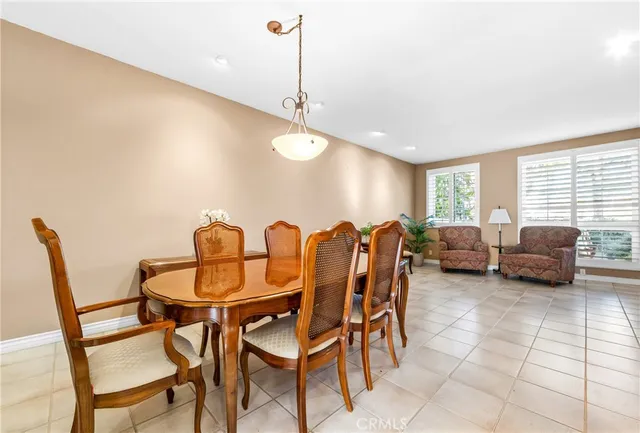 a view of a dining room with furniture and a chandelier