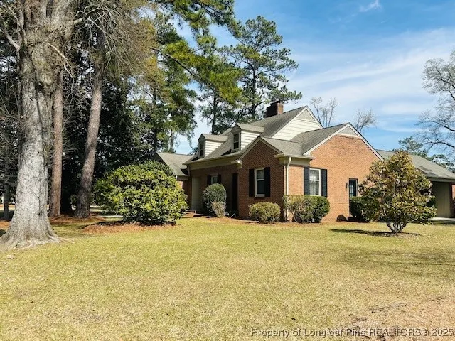 a front view of a house with a yard covered with snow