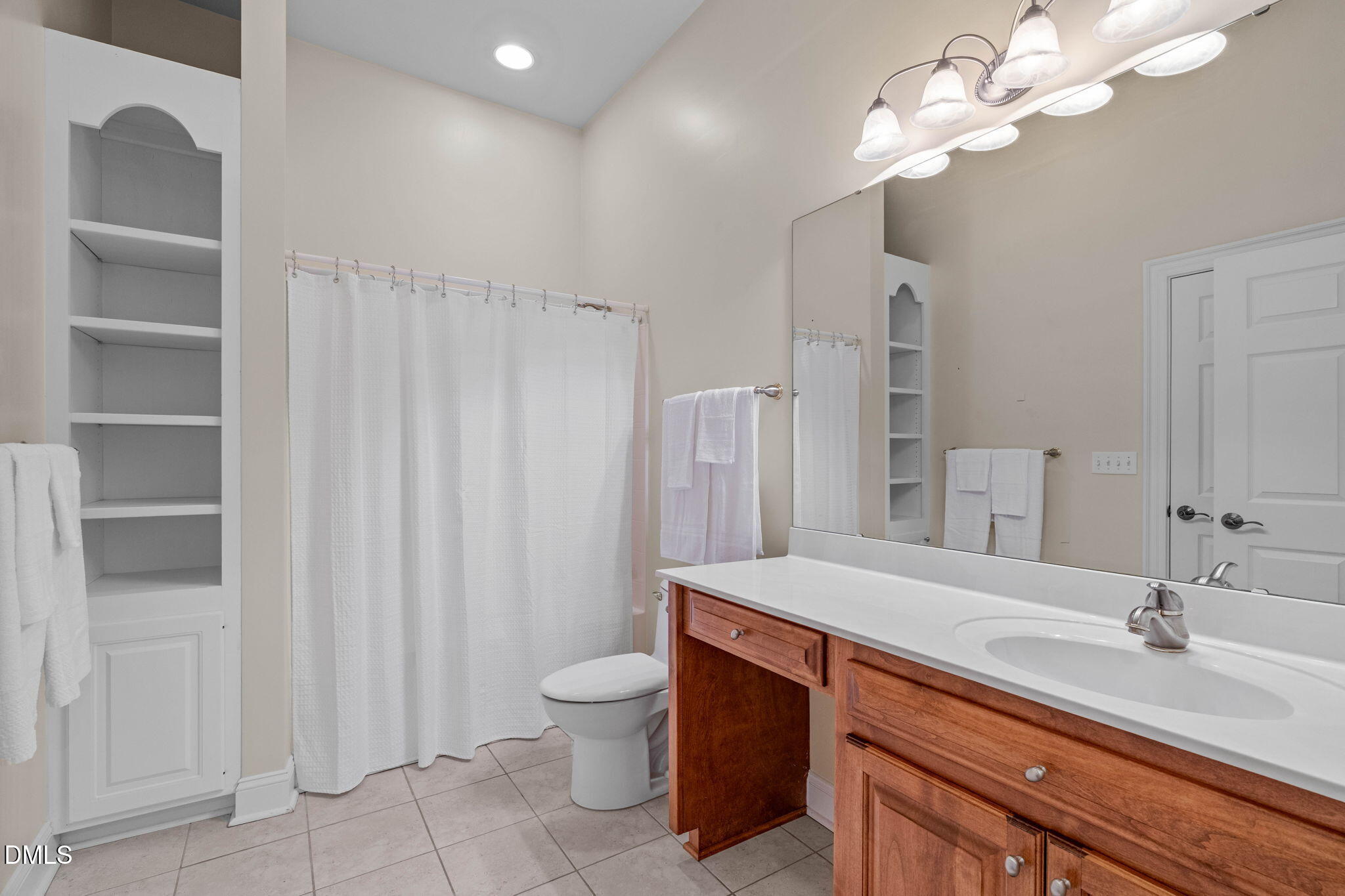 10917 Jordan Road Raleigh, NC 27603 - Photo 28 of 58 a bathroom with a double vanity sink a toilet and a mirror