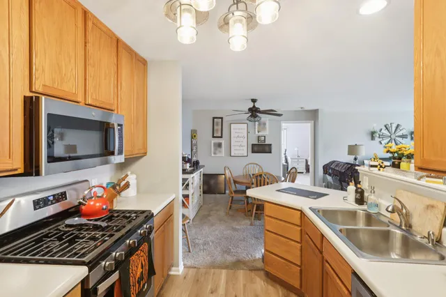 a kitchen that has a sink and a stove top oven