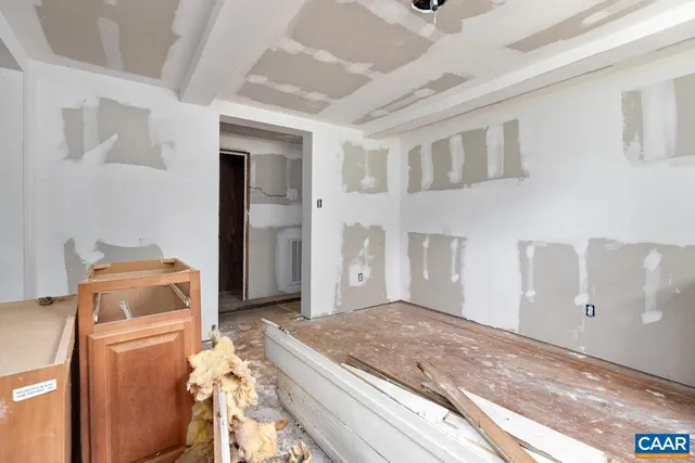 a view of walk in closet with wooden floor and windows