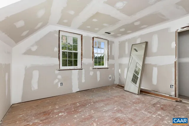 a view of a bedroom with wooden floor and stairs
